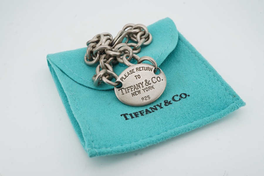 Tiffany & Co, a silver 'Return to Tiffany' bracelet, circa 2006, the oval plaque reading 'Please Return to Tiffany & Co. New York 925' on a belcher link chain, in silver, length 21.5cm, British hallmarks for silver, make